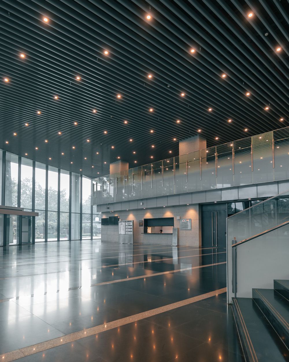 Corporate lobby with a slatted ceiling and warm lighting