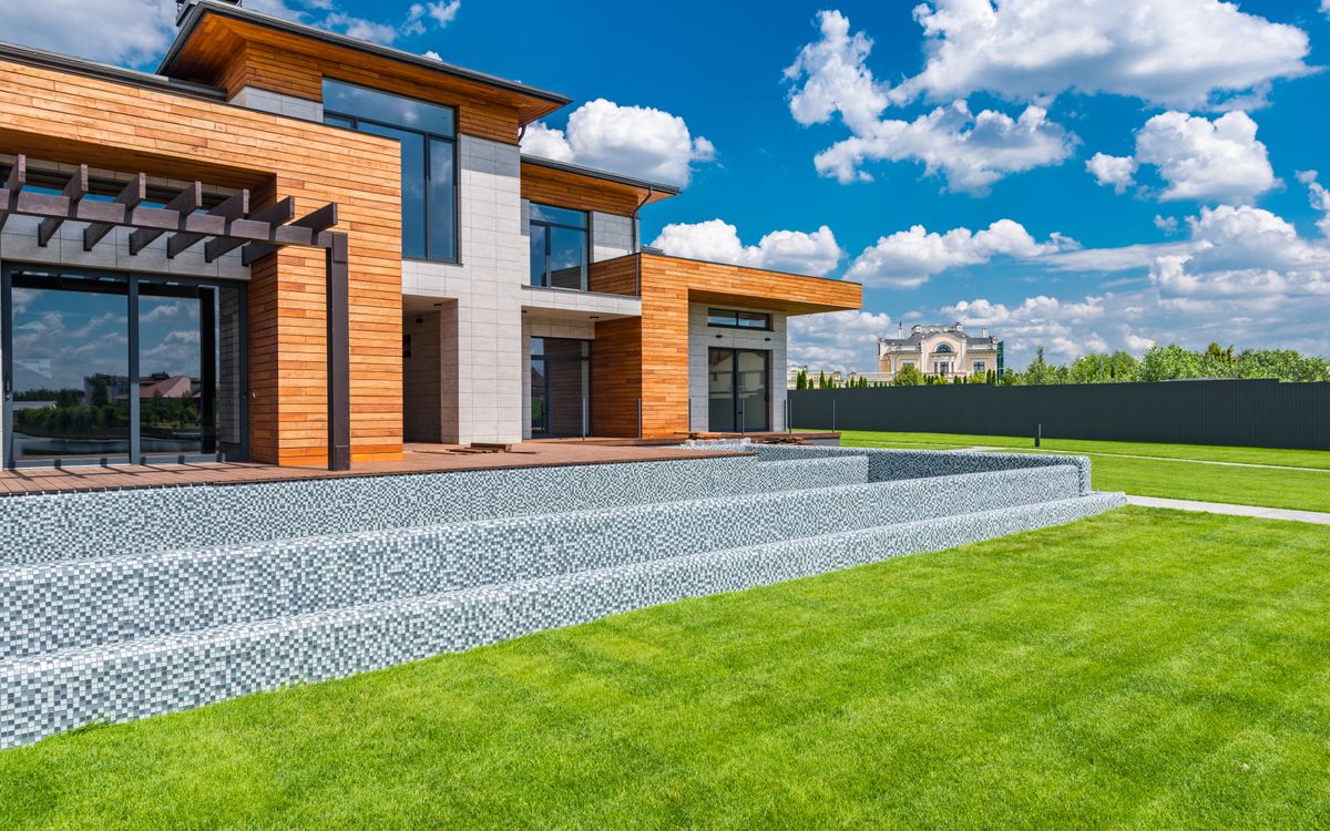 Contemporary house with panoramic glazing and a lawn