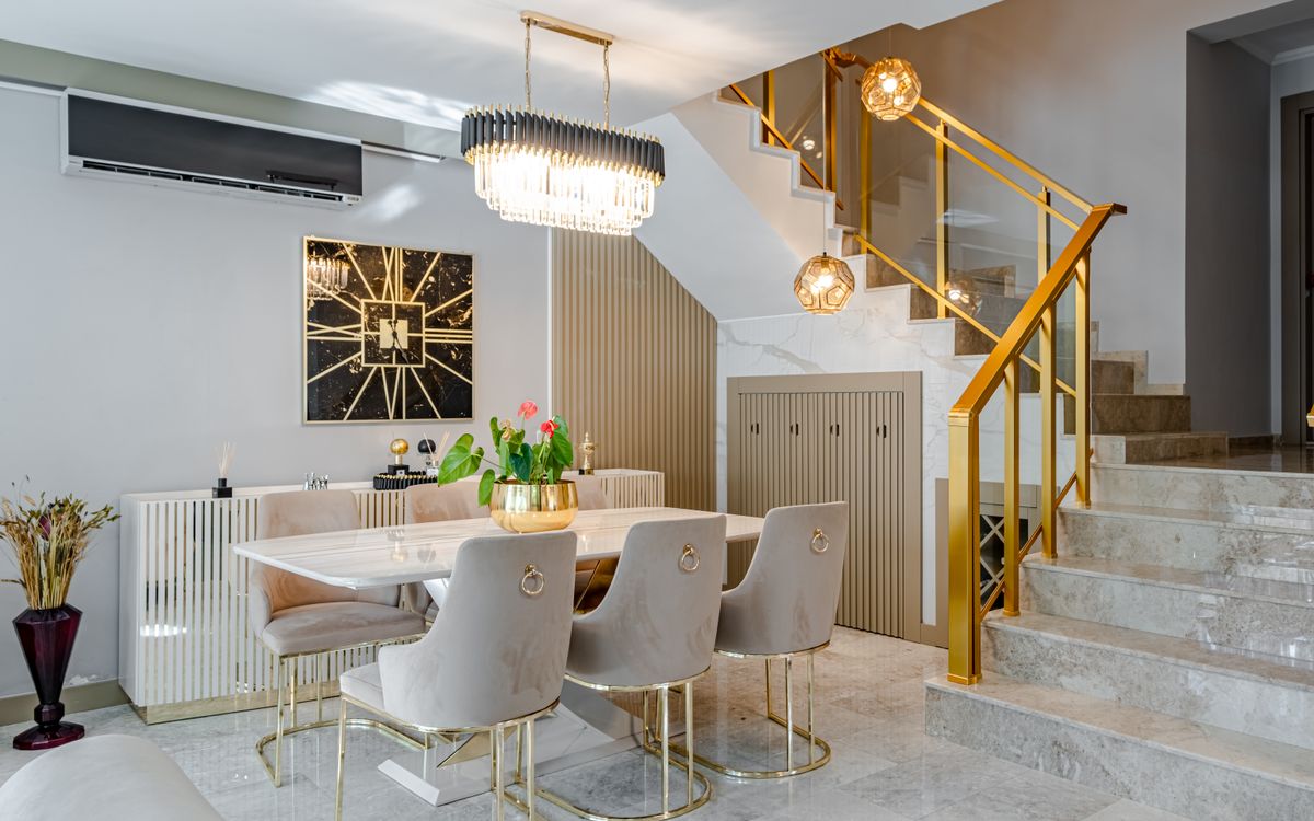 Dining table and staircase in a marble-lined interior