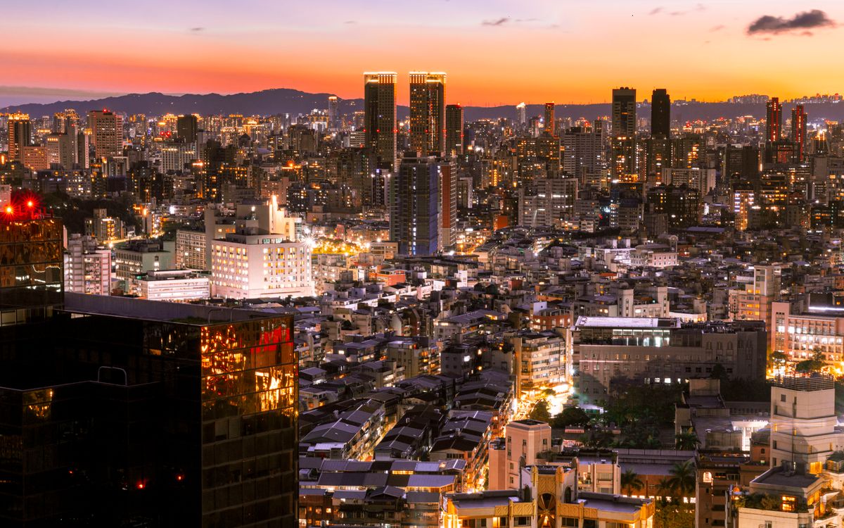 City towers lit at dusk seen from above
